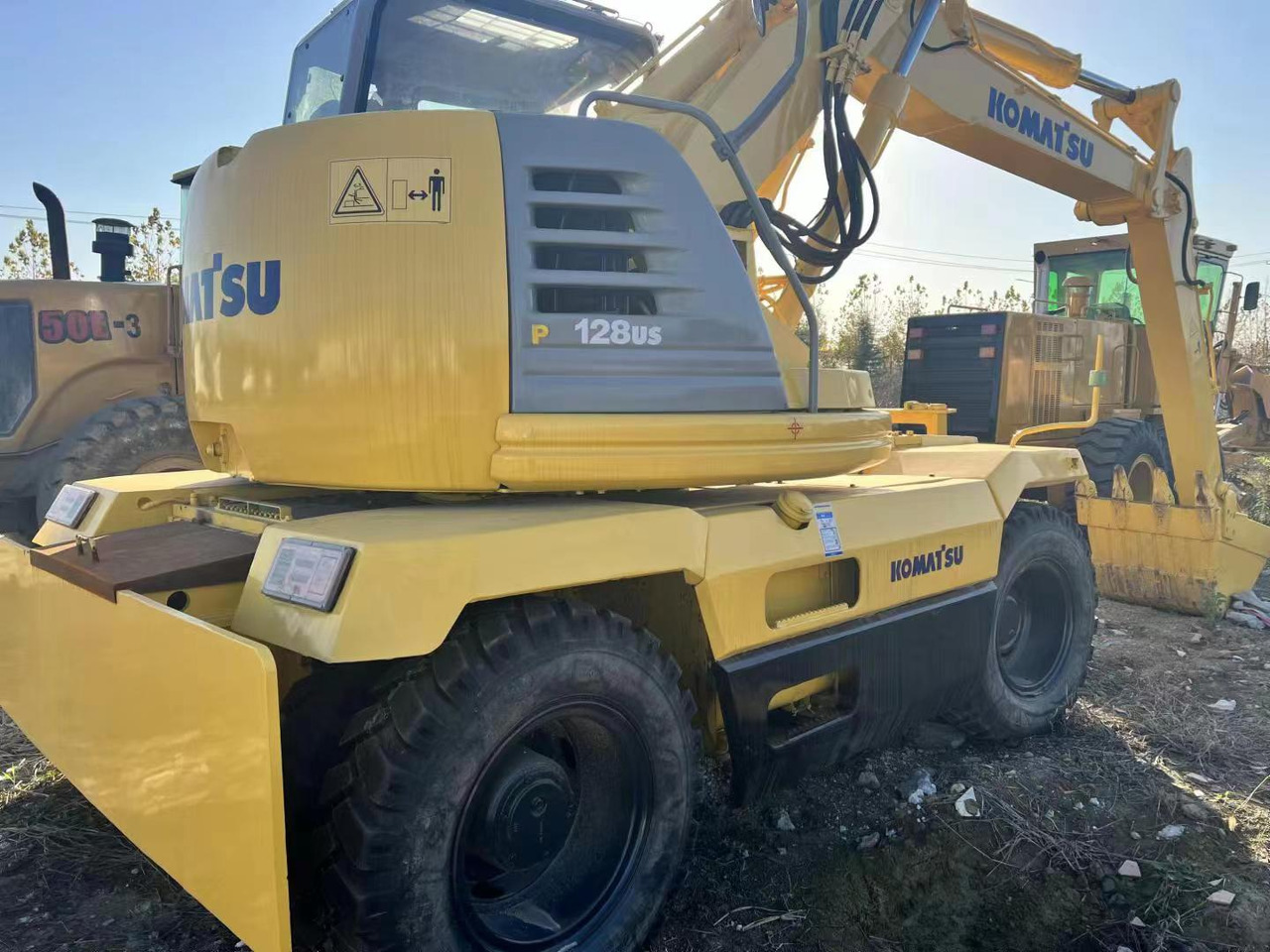 KOMATSU PC128US - Колёсный экскаватор: фото 2 KOMATSU PC128US - Колёсный экскаватор: фото 2