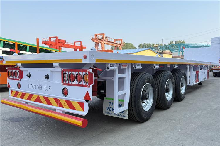 TITAN 3 Axle Flatbed Semi Trailer with Front Wall for Sale In Dominican - Полуприцеп-контейнеровоз/ Сменный кузов: фото 4 TITAN 3 Axle Flatbed Semi Trailer with Front Wall for Sale In Dominican - Полуприцеп-контейнеровоз/ Сменный кузов: фото 4